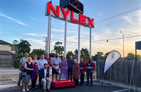 Mayor Hadi Saab, Councillors and representatives from Mordialloc and District Historical Society and Bunnings standing under the restored Nylex clock