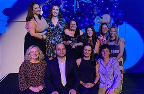 Kingston staff huddled at the Aquatic & Recreation Victoria Industry Gala Awards, celebrating their win of the Swim School Award.