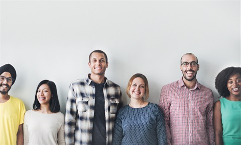 A line of diverse people standing and smiling.