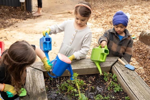 children watering a garden at kinder