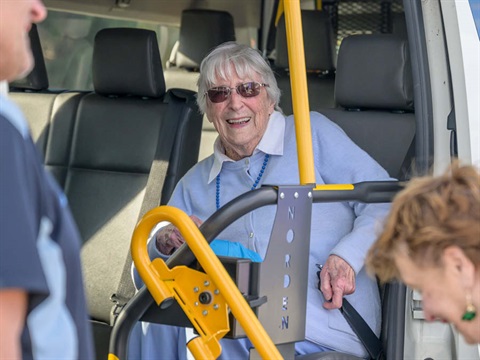 A woman sitting in a community bus