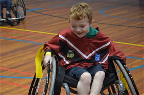 Child in a wheelchair playing wheelchair basketball