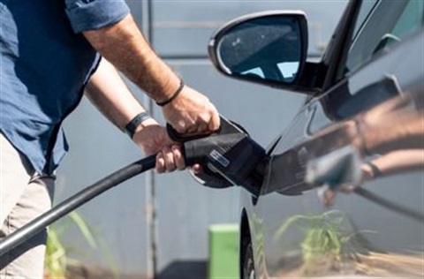 Someone charging an electric vehicle