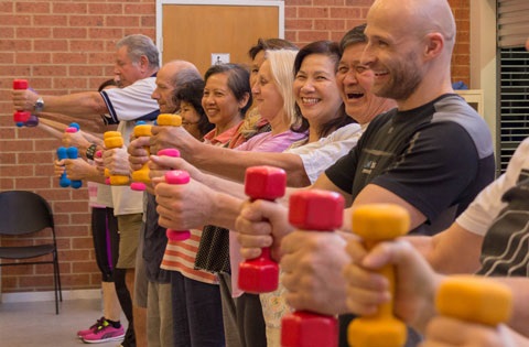 Diverse group engaging in an exercise activity with weights