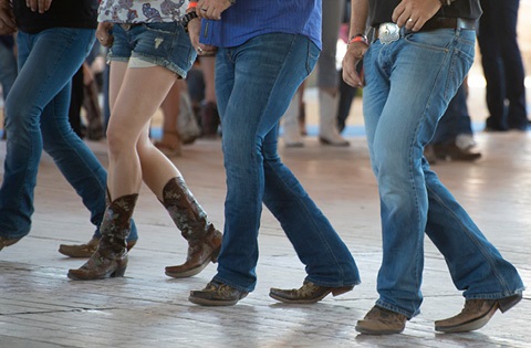 Four people line dancing