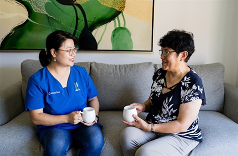 Two women chatting on a couch