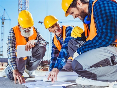 Construction workers going over plans.