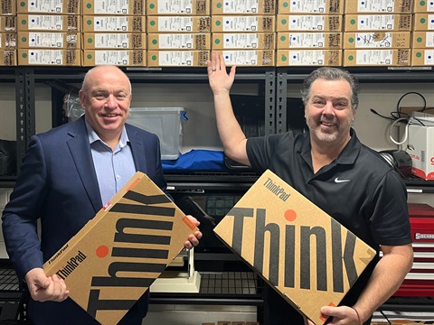 Kingston CEO Peter Bean meets with SELLEN CEO Andrew Simmons to officially hand over laptops.