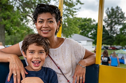 A young boy and his mum enjoying a ride.