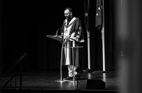 Cr Steve Staikos standing at a microphone.