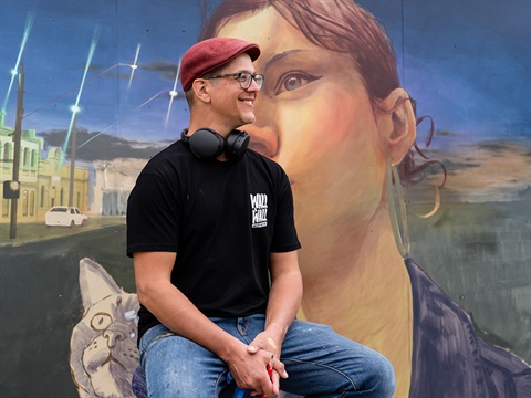 Artist Claudio Mantuano in front of his mural.