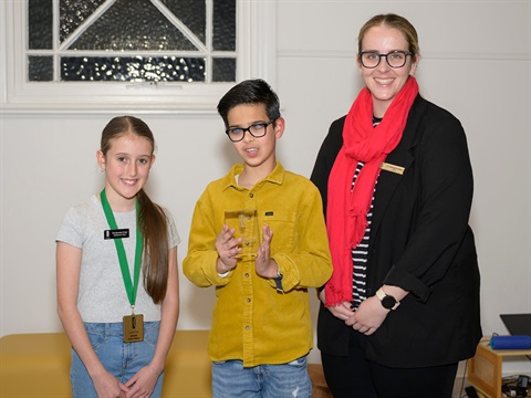 Kingston's Young Citizen of the Year Mikail Liakos (centre) is congratulated by Junior Mayor Evie Brandon-Cope (left) and Mayor Cr Georgina Oxley (right). 