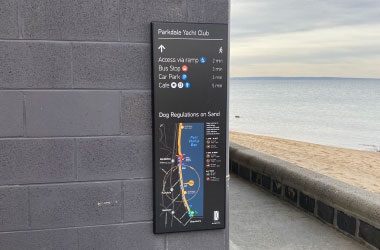 A wayfinding sign at Parkdale Yacht Club with distances to a bus stop, car park and cafe 