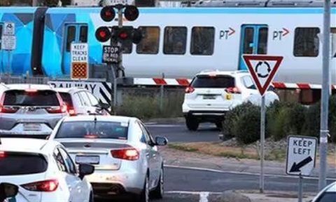 Traffic banked up at a level crossing.